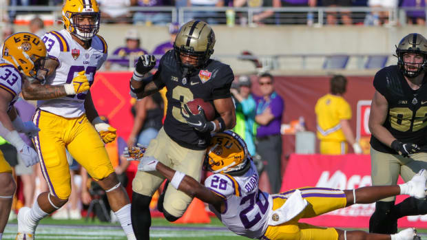 Purdue Boilermakers wide receiver Tyrone Tracy (3) avoids a tackle by LSU Tigers safety Major Burns (28) during the second half at Camping World Stadium.